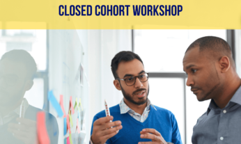 Two men having a discussion in front of a whiteboard with post-it notes on it